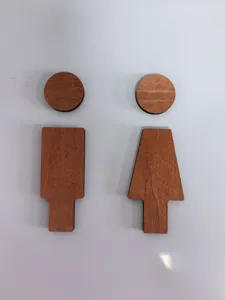 Wooden toilet sign detail shot showing male and female symbol design for wall decor