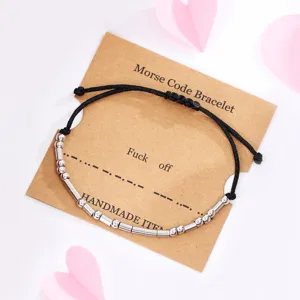 Morse code bracelet detail showing black wax cord and silver metal tubes on card.