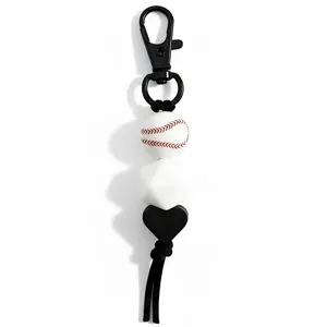Close-up detail of sports baseball keychain pendant with silicone beads and black tassel.