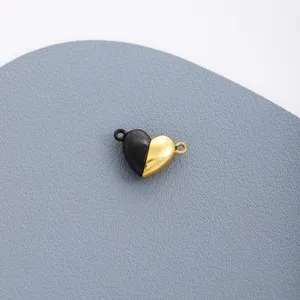 Close-up detail shot of stainless steel black and gold heart magnetic DIY jewelry charm component