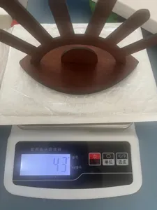 Detail view of the unique eye-shaped wooden jewelry display stand showing its lightweight design.