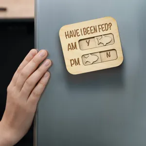 Wooden pet feeding reminder magnet for cats and dogs with sliding AM PM tracker design.