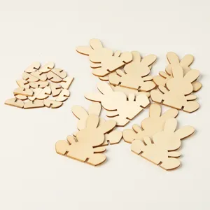 Wooden Easter bunny cutouts detail shot, DIY craft unpainted wooden blanks for kids painting.