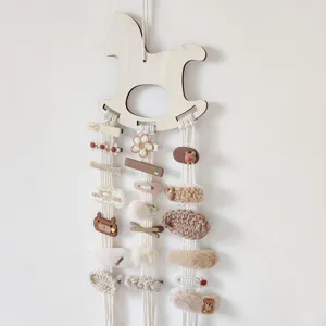 Wooden rocking horse hair clip organizer wall hanging detail displaying cute hairpins and clips.