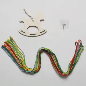 Detailed view of DIY wooden rocking horse hanging accessory with colorful cotton cords and hook.