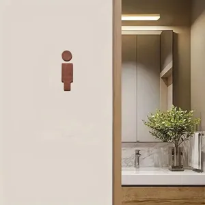 Wooden toilet sign detail view showing minimalist bathroom wall decor with smooth surface texture.