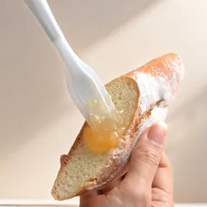 Mini white jam scraper for kitchen use, cute standing spatula for spreading butter and fruit spread.