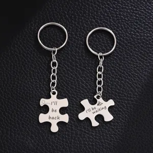 Stainless steel couple puzzle keychain set with engraved matching love quotes for lovers.