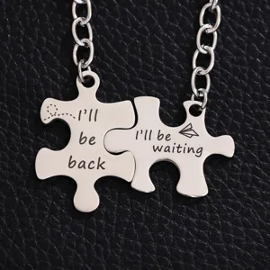 Stainless steel puzzle couple keychain detailed shot showing engraved English text design.