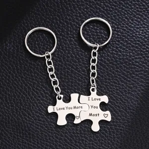 Detailed shot of stainless steel puzzle couple keychains with romantic I love you engraving.
