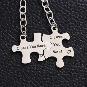 Stainless steel puzzle keychain detail, engraved love quote couples gift, smooth metal texture close-up.
