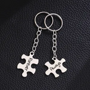 Stainless steel couple puzzle keychain detail shot, engraved with forever and always text.