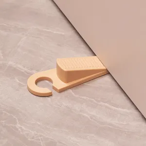 Plastic door stopper wedge with convenient hanging ring design for home floor protection.