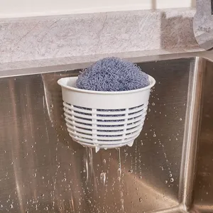 Plastic sink hanging basket with suction cup and cleaning scrubber for kitchen sink drainage storage.