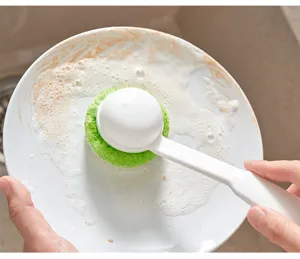 Long-handled cleaning brush with green sponge head for efficient kitchen dishwashing and pot scrubbing.