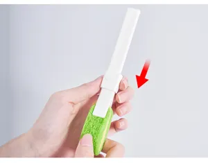 Mini sponge cleaning brush detail view, portable kitchen and bathroom cleaning tool with handle.