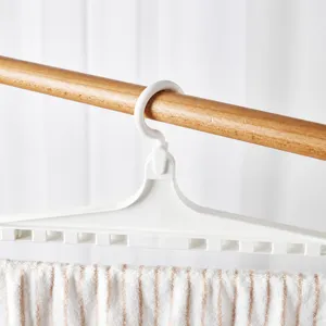 White plastic clothes hanger with 360 degree rotation hook for drying towels and garments.