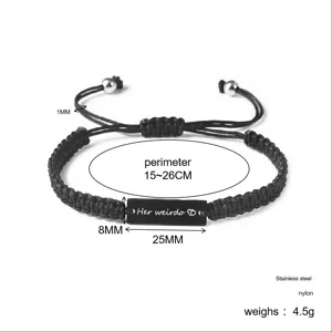 Detail view of adjustable black braided cord bracelet featuring a stainless steel engraved bar.