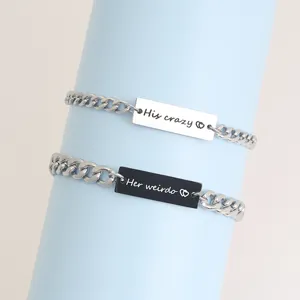 Stainless steel couple bracelets detail featuring black and white ID plates with engraved text.