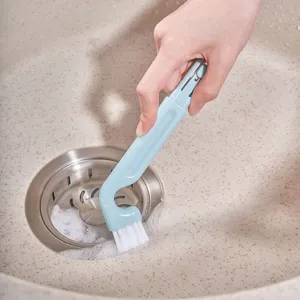 Japanese kitchen sink cleaning brush with angled handle and white bristles for drain cleaning.