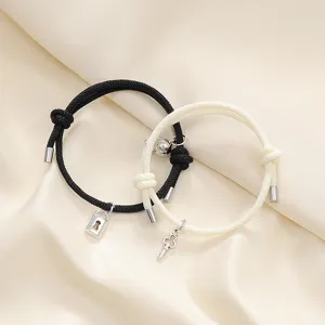 Detailed view of magnetic lock and key matching braided rope couple bracelets set.