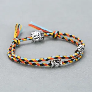 Handmade woven multi-color cotton rope bracelet featuring alloy Buddha head and carved beads detail.