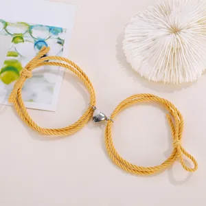Magnetic matching heart couple bracelets made of yellow braided rope for lovers and friends.