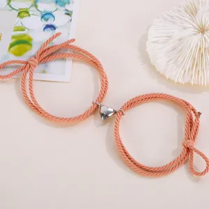 Couple magnetic heart braided rope bracelet set, matching pink love charm jewelry detail.