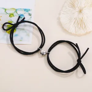 Couple magnetic heart black rope bracelets set, matching minimalist braided friendship jewelry item.