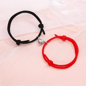 Couple magnetic heart bracelet set, black and red braided rope matching jewelry detail view.