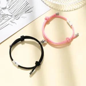 Close-up view of the magnetic couple bracelet clasp and braided rope texture details.