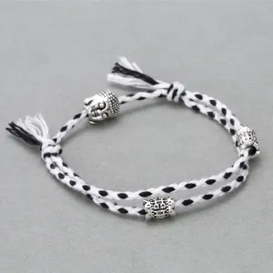 Minimalist black white braided rope bracelet with alloy buddha head and charm for daily wear.