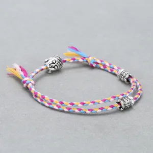 Handmade colorful woven rope bracelet with alloy Buddha head and engraved metal cylinder charms