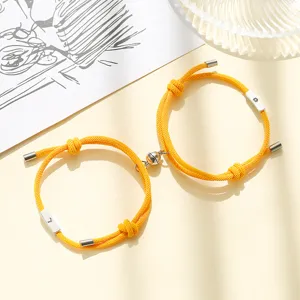 Sun and moon magnetic couple bracelet detailed view, matching braided charm wristband jewelry.