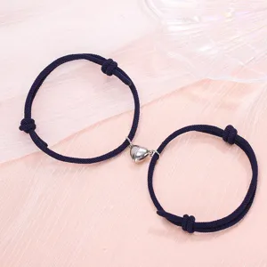 Minimalist couple braided bracelets with magnetic heart charm, stylish matching jewelry set.