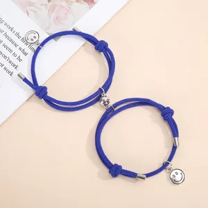 Blue handmade woven magnetic couple bracelets with cute silver smiley face charms set.