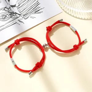 Red cord magnetic couple bracelets with sun and moon charms, matching alloy detail for lovers.