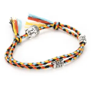 Handmade colorful cotton rope bracelet with alloy Buddha head charm and vintage beads.
