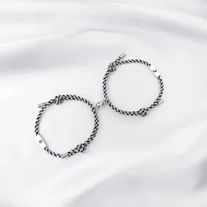 Stainless steel sun and moon magnetic couple bracelets detail, black white braided rope design.