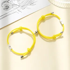 Yellow magnetic couple bracelets set with sun and moon charms, braided rope friendship jewelry.