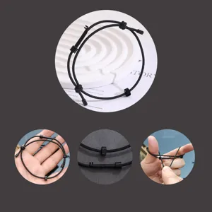 Schwarzes Notfall-Überlebensseilarmband mit Zahnraddetail, verstellbare taktische Ausrüstung.
