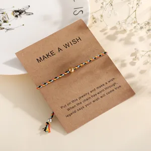 Woven colorful thread bracelet with golden bead and kraft paper wish card packaging for women.