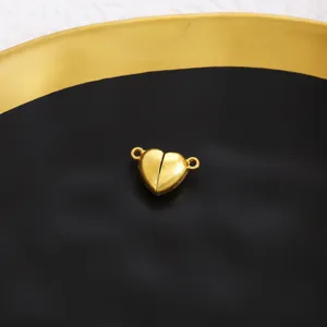 Close up view of heart magnetic clasp for DIY jewelry making and necklace, gold finish.