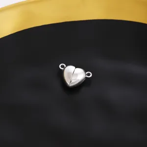 Close-up detail of silver heart magnetic clasp connector for DIY jewelry making, necklace and bracelet.