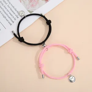 Handmade woven couple magnetic matching bracelets with cute metal smiley face charms.