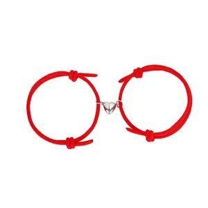 Close-up detail of the red cord couple magnetic heart bracelet showing clasp and texture.