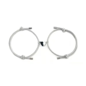Grey braided rope couple bracelets with magnetic split heart charm, perfect for lovers.
