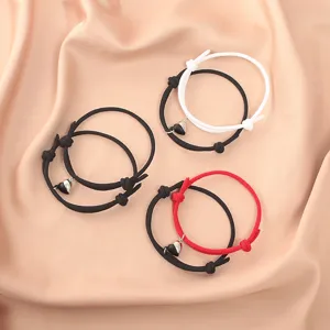 Detail view of magnetic heart couple bracelets with braided rope design, perfect gift for besties.