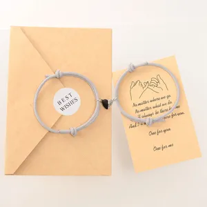 Couple magnetic matching heart braided rope bracelets set with greeting card gift packaging.