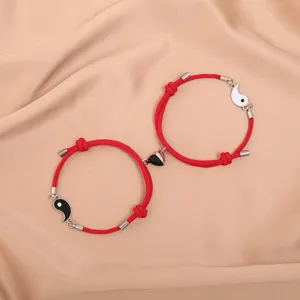 Matching magnetic red cord couple bracelets with yin yang design for lovers and friends.